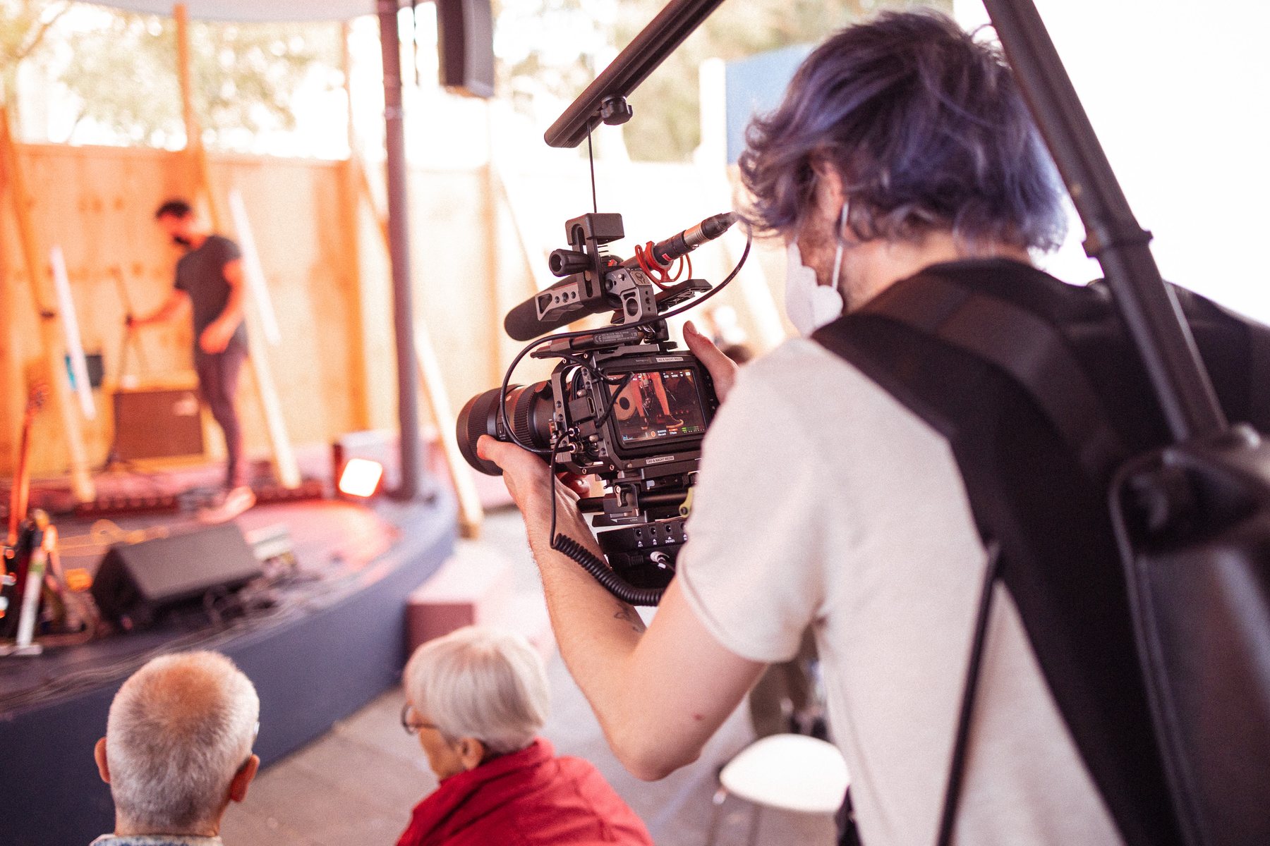 Camera team filming a performance in the Pallaswiesen-Morneweg district