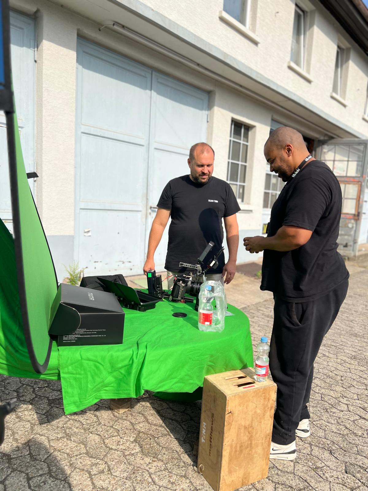 Crew next to green screen equipment on set